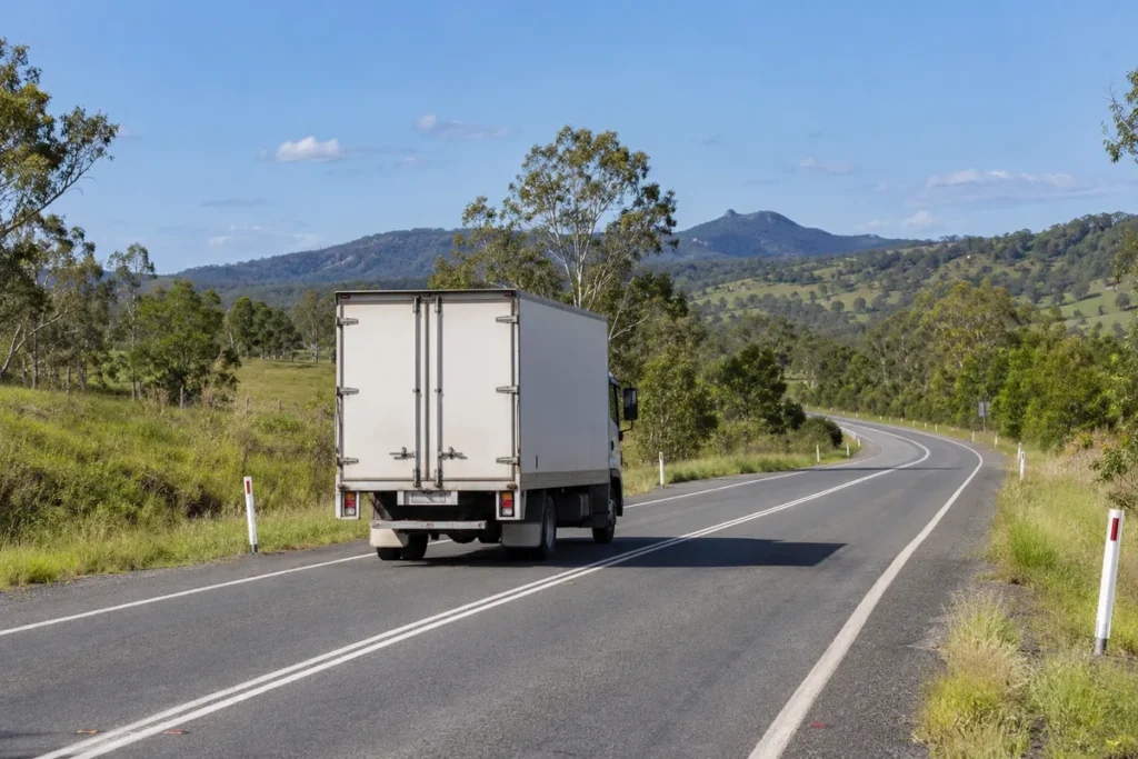 Furniture-removal truck travelling along a Queensland hinterland road